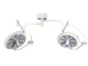 Dual ceiling-mounted surgical lights with articulating arms for operating rooms.